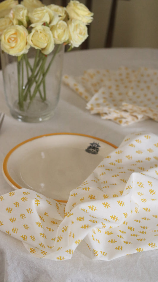 off white napkin with yellow motifs